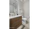 A modern bathroom features a wood vanity with a white countertop and a decorative textured wall at 5533 E Stella Ln, Paradise Valley, AZ 85253