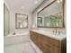 Relaxing bathroom with a soaking tub, double sink vanity, and large mirrors at 5533 E Stella Ln, Paradise Valley, AZ 85253
