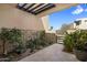Enclosed patio area has a walkway leading to a dark metal gate. Desert landscaping and mountain views in the background at 5533 E Stella Ln, Paradise Valley, AZ 85253