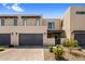 A contemporary home featuring a light beige stucco exterior, a paved driveway and a two-car garage at 5533 E Stella Ln, Paradise Valley, AZ 85253