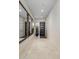 Bright and inviting hallway featuring neutral tile floors, a dark front door, and mirrored decor at 5533 E Stella Ln, Paradise Valley, AZ 85253