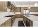 Modern kitchen with stainless steel appliances, light wood cabinets, and a spacious white countertop island at 5533 E Stella Ln, Paradise Valley, AZ 85253