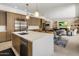 Open kitchen featuring a white island, stainless steel appliances, with seamless flow into the dining and living areas at 5533 E Stella Ln, Paradise Valley, AZ 85253