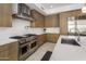 Bright kitchen features stainless steel appliances, light wood cabinetry, and white countertops at 5533 E Stella Ln, Paradise Valley, AZ 85253
