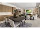 This open-concept living space offers a seamless blend of a dining area and a cozy living room with a fireplace at 5533 E Stella Ln, Paradise Valley, AZ 85253