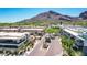 Aerial neighborhood view of desert community featuring palm trees, cacti, and gated entry at 5533 E Stella Ln, Paradise Valley, AZ 85253