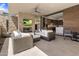 Inviting covered patio featuring a fireplace, TV, and modern outdoor furniture at 5533 E Stella Ln, Paradise Valley, AZ 85253