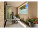 Relaxing patio with comfortable chair, privacy wall, and lush potted plants at 5533 E Stella Ln, Paradise Valley, AZ 85253