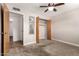 Bedroom with carpet, closet space, and neutral paint, and a ceiling fan at 5627 E Covina Rd, Mesa, AZ 85205