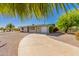 Exterior view of home with desert landscaping and a driveway leading to the garage at 5627 E Covina Rd, Mesa, AZ 85205