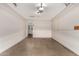 Spacious garage with concrete floor and exposed brick walls offers ample room for parking and storage at 5627 E Covina Rd, Mesa, AZ 85205