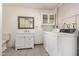 Bright laundry room featuring a washing machine, dryer, sink, and ample storage space at 5627 E Covina Rd, Mesa, AZ 85205