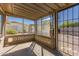 Enclosed patio featuring a screen door, decorative concrete block, and views of the home's backyard at 5627 E Covina Rd, Mesa, AZ 85205