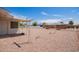 Expansive backyard featuring low maintenance gravel, and a covered patio for outdoor enjoyment at 6043 E Des Moines St, Mesa, AZ 85205