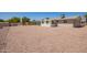 Wide backyard with gravel offering ample space and convenience; great for customization and activities at 6043 E Des Moines St, Mesa, AZ 85205
