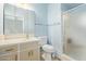 Cozy bathroom featuring a shower, toilet, and vanity with cabinet storage for convenience at 6043 E Des Moines St, Mesa, AZ 85205