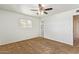 Bedroom with carpet, a ceiling fan, and a view into the hallway at 6043 E Des Moines St, Mesa, AZ 85205