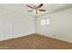 Neutral bedroom with fan and two closets; ready for personalization and comfortable living at 6043 E Des Moines St, Mesa, AZ 85205
