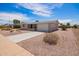 Charming single-story home with desert landscaping, long driveway and an attached two car garage at 6043 E Des Moines St, Mesa, AZ 85205