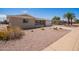 Single story home with desert landscaping, a concrete driveway and an attached two car garage at 6043 E Des Moines St, Mesa, AZ 85205