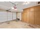Spacious garage with storage cabinets and overhead door, ready for vehicles and projects at 6043 E Des Moines St, Mesa, AZ 85205