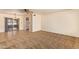 Open-concept living room with neutral carpet, a ceiling fan, and access to the patio at 6043 E Des Moines St, Mesa, AZ 85205