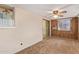 Cozy living room featuring wood paneling, an AC unit, and a sliding door to the outdoors at 6043 E Des Moines St, Mesa, AZ 85205