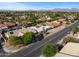 This aerial view highlights a neighborhood with diverse homes, mature trees, and mountain views in a desirable community at 6126 E Paradise Ln, Scottsdale, AZ 85254