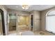 Spacious bathroom with a soaking tub, glass-enclosed shower, and natural light from a window at 6126 E Paradise Ln, Scottsdale, AZ 85254