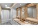 Bright bathroom with double sinks, granite countertops, a skylight and a shower-tub combination at 6126 E Paradise Ln, Scottsdale, AZ 85254