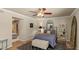 Comfortable bedroom with a ceiling fan, an accent rug, with light entering from the window at 6126 E Paradise Ln, Scottsdale, AZ 85254