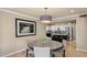 Open concept dining room with view to a modern kitchen featuring white cabinets at 6126 E Paradise Ln, Scottsdale, AZ 85254