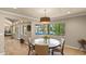 Bright dining room with pool views, pendant lighting, and seating for four at 6126 E Paradise Ln, Scottsdale, AZ 85254