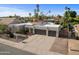 Modern home with a desert landscape, a three-car garage and a well-maintained yard at 6126 E Paradise Ln, Scottsdale, AZ 85254