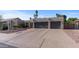 Lovely single-story home boasting a low-maintenance yard and a large paved driveway leading to an attached two-car garage at 6126 E Paradise Ln, Scottsdale, AZ 85254