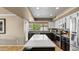 Modern kitchen featuring white cabinets, dark island and stainless steel appliances at 6126 E Paradise Ln, Scottsdale, AZ 85254