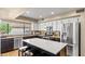 Modern kitchen featuring white cabinets, dark island and stainless steel appliances at 6126 E Paradise Ln, Scottsdale, AZ 85254