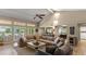 Spacious living room with a ceiling fan, vaulted ceilings, and multiple windows providing ample natural light at 6126 E Paradise Ln, Scottsdale, AZ 85254