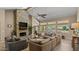 Warm, inviting living room with a floor-to-ceiling stone fireplace and large windows overlooking the backyard at 6126 E Paradise Ln, Scottsdale, AZ 85254