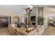 Bright, open-concept living room with a stacked stone fireplace and direct view of the backyard at 6126 E Paradise Ln, Scottsdale, AZ 85254