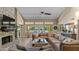Bright living room featuring vaulted ceilings, modern furniture, and views of the lush backyard at 6126 E Paradise Ln, Scottsdale, AZ 85254