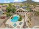 Stunning aerial view of the backyard featuring a private pool, spa, lounge area, and lush landscaping at 6713 E Riverdale St, Mesa, AZ 85215