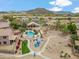 Sweeping aerial view of a home featuring a backyard pool, playground and desert landscaping at 6713 E Riverdale St, Mesa, AZ 85215