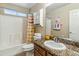 Clean bathroom with a vanity, granite countertops, shower-tub combo, and good lighting at 6713 E Riverdale St, Mesa, AZ 85215