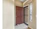 Open entryway featuring tile flooring, a decorative security door, and a window with stained glass at 6713 E Riverdale St, Mesa, AZ 85215