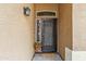 Welcoming entryway with decorative glass, a security screen door, and a stylish light fixture at 6713 E Riverdale St, Mesa, AZ 85215