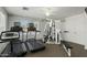 Well-equipped home gym featuring treadmills, a multi-station weight machine, and a ceiling fan at 6713 E Riverdale St, Mesa, AZ 85215