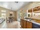 Eat-in kitchen with view of living and dining area and access to backyard at 6713 E Riverdale St, Mesa, AZ 85215