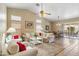 Bright open living space with vaulted ceilings, dining area, and sliding door access to the outdoor patio at 6713 E Riverdale St, Mesa, AZ 85215