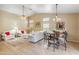 Open-concept living area with dining space, high ceilings, neutral tones, and lots of natural light at 6713 E Riverdale St, Mesa, AZ 85215